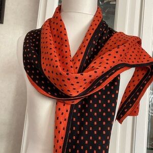 NWT Black and orange print scarf. Reverse print on each side. 74” x 12”